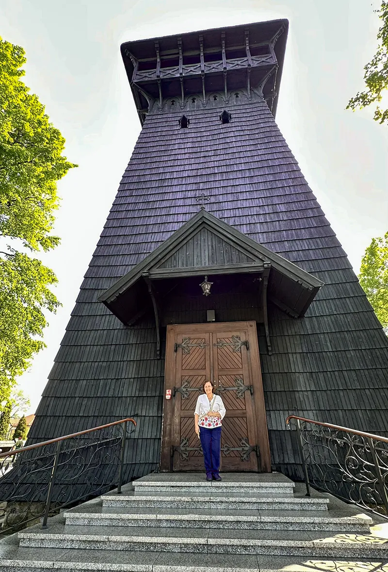 Sônia na porta da Igreja de São Estanislau, em Skrzyszów, Polônia Uma das Igrejas de Madeira da Pequena Polônia, a Igreja de São Estanislau, em Skrzyszów, Polônia